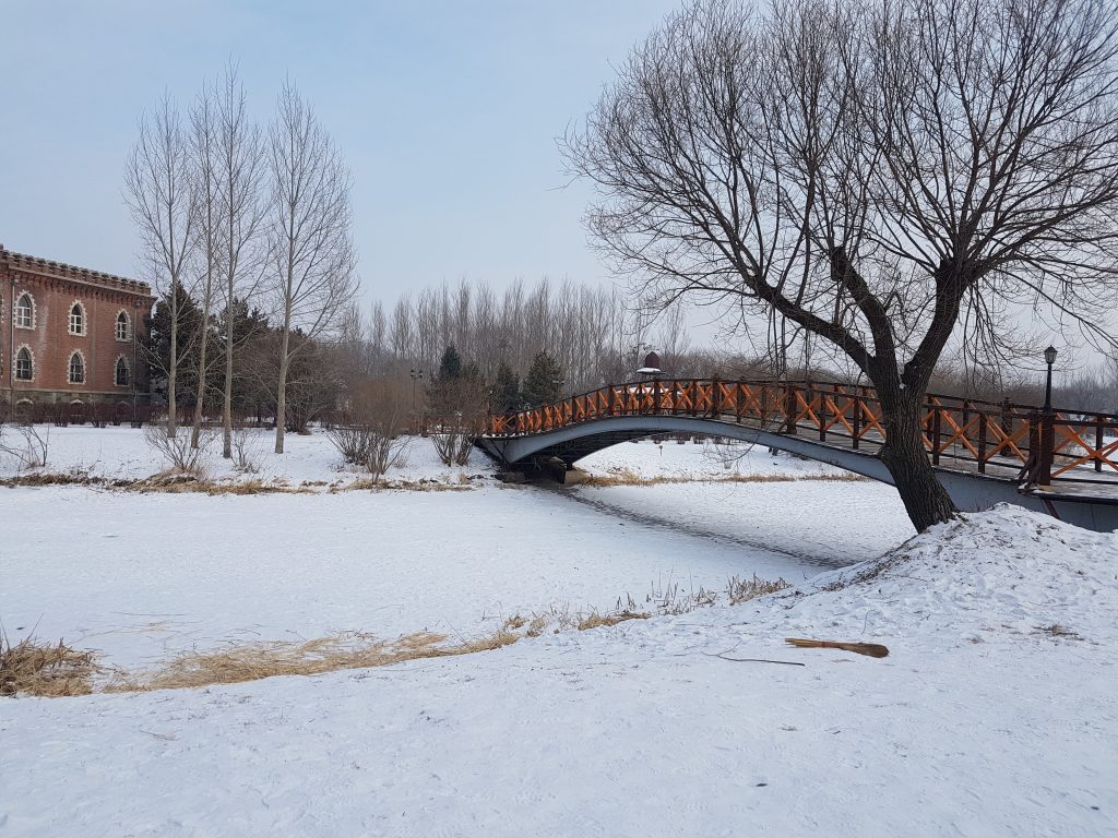 Bridge over a frozen river at Volga Manor, Harbin, China